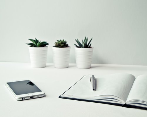 A clean, organized desk workspace with natural light